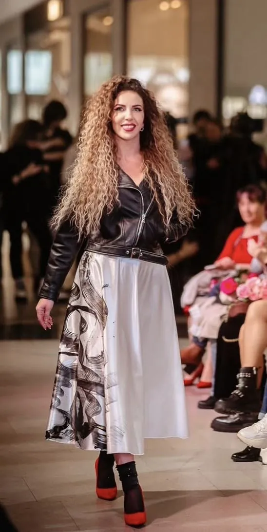 Hand-painted skirt on the runway, with a leather jacket